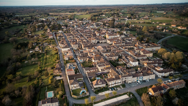 Beautiful wide drone shot of the little village of Monpazier in Périgord at sunset, Dordogne