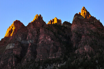 Late afternoon alpenglow on the jagged peaks of Sievers Mountain South, near Maroon Bells and...