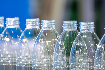 The empty PET bottles  on the conveyor belt for filling process in the drinking water factory.
