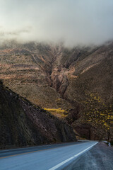 Low clouds over the winding Cuesta de Lipán mountain road, on the way down to Purmamarca town in...