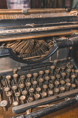 A typewriter is a mechanical or electromechanical machine for typing characters. Selective focus shot.