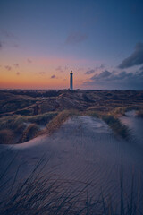 Lighthouse Lyngvig Fyr at the danish north sea coast at down - obrazy, fototapety, plakaty