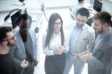 close up.business team discusses standing behind a glass wall