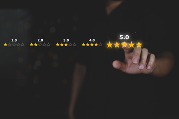 Customer review good rating concept hand pressing five star on visual screen and positive customer feedback testimonial.