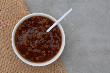 Traditional South African fruit chutney, a popular condiment in a white bowl with copy space