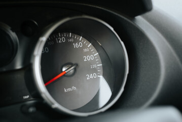 Naklejka premium Close-up of car speedometer with red arrow and dial. Side view dashboard