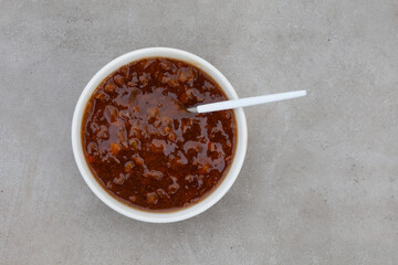 Traditional South African fruit chutney, a popular condiment in a white bowl with copy space