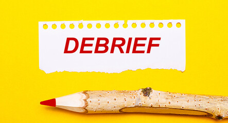On a bright yellow background, a large wooden pencil and a sheet of torn paper with the text...