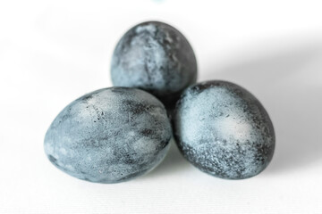 Gray Easter eggs lie on the table. Gaussian blurred background. Close-up