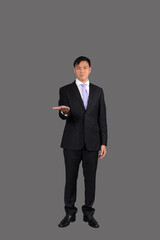 Portrait of attractive businessman Asian standing against on gray background with copy space and clipping path