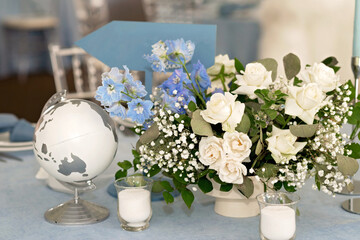 Floral table decoration for holidays and weddings. Wedding travelers, tourists. A set table for a celebration, event, party or wedding in an outdoor restaurant. Soft selective focus.