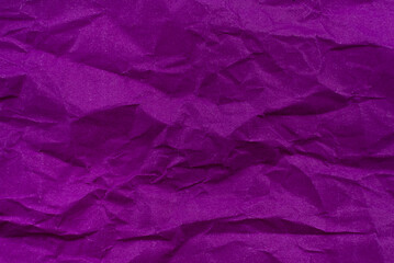 Background from crumpled paper in purple or lilac color. Paper texture with wrinkles and folds