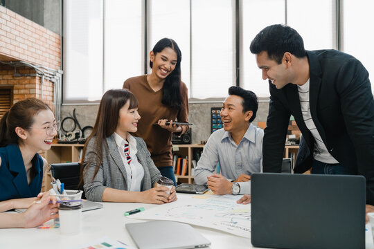 Multiracial Group Of Young Creative People In Casual Wear Meeting Brainstorming Ideas About New Paperwork Project Colleagues Working Together Planning Success Strategy Enjoy Teamwork In Small Office