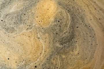 Coffee texture background. Strong espresso extreme dark coffee brown froth closeup