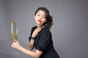 beautiful woman in a black gown on a solid background