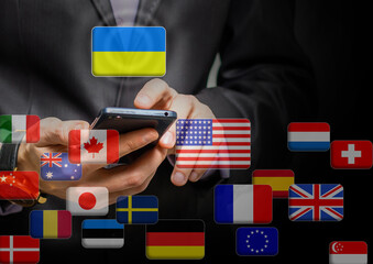 Hand pushing on a touch screen interface, choosing Ukraine. flags of the world