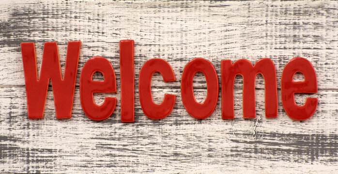 Blackboard sign with the text Welcome. A nameplate saying "welcome"