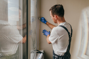 Young man using waterproof silicone and spatula