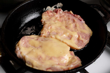 Meat chop in batter is fried in a pan. Cooking meat food.
