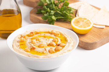 Delicious hummus with chickpeas, olive oil, lemon and pita bread. Vegetarian food concept.