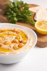 Delicious hummus with chickpeas, olive oil, lemon and pita bread. Vegetarian food concept.