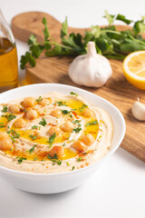 Delicious hummus with chickpeas, olive oil, lemon and pita bread. Vegetarian food concept.