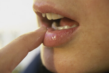 Close-up of a person's finger on their lips