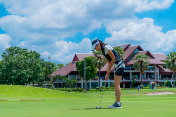 Lifestyle. Girl playing golf on green grass on a sunny day.