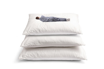 Fototapeta na wymiar Rear view shot of a man sleeping on a pile of big pillows
