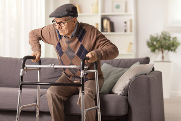 Elderly man on a sofa trying to walk with a walker