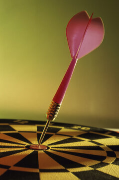 Close-up of a dart in the bull's-eye of a dartboard