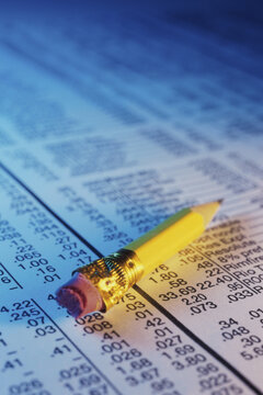 Close-up of a pencil on stock listings