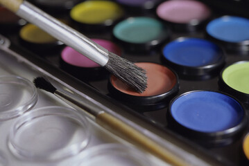 Close-up of a paintbrush on a paint palette