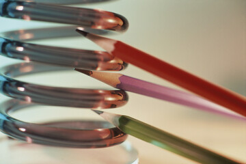 Pencils between spring coils