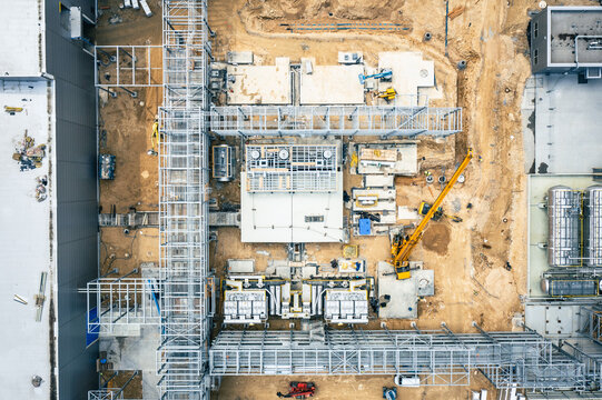 Factory Building. Aerial Industrial Construction Site with Crane and Construction Equipment.