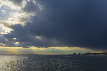 Obraz premium Panoramic view to Grado town on Adriatic sea on a sunset before thunderstorm