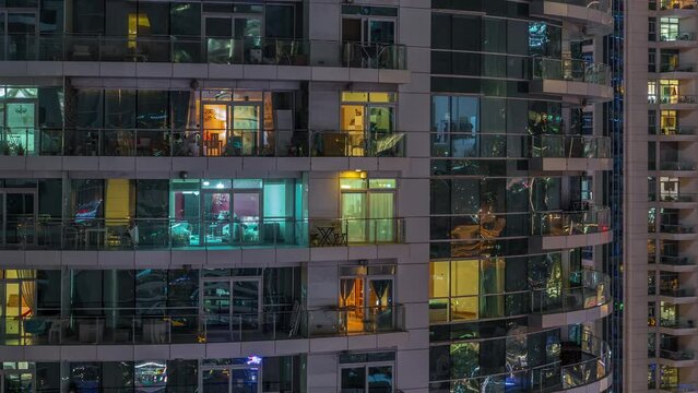 Flat night panorama of multicolor light in windows of multistory buildings aerial timelapse.