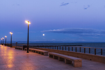 Naklejka premium View to moonrise from seafront along Adriatic sea in Grado, Italy