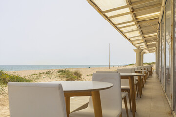 Panoramic view to Balearic sea from restaurant on yellow sandy beach with dunes