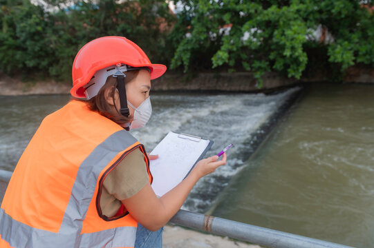 Asian Female Engineering Working . At Sewage Treatment Plant,Marine Biologist Analysing Water Test Results,World Environment Day Concept