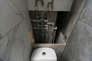 Water pipes, valves and manometers inside house, system with electric pumps and heaters. Metal...