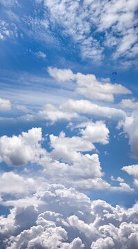 Blue sky, clouds, and Paraglider (digital composite)