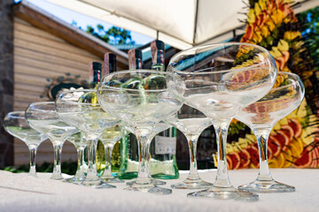 Wine glasses on a background of alcohol and a pyramid of fruit