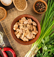 Pickled mushrooms in a bowl.Fermented food. Mushrooms with herbs and spices. Homemade food. Pickled vegetables. Vegetarian food. View from above. copy space