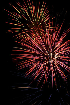 Low angle view of fireworks display at night