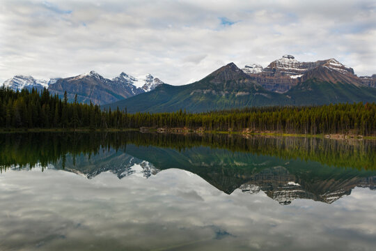 Reflection of clouds and mountains in a lake, Lake Herbert, Banff National Park, Alberta, Canada