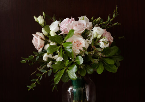 Dramatic Black Background with Romantic Wedding Bouquet with Roses in White and Pink with Gorgeous Deep Green Leaves