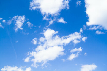 Naklejka na ściany i meble Cumulus clouds. White clouds on a blue background.