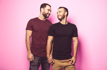 Young homosexuals gay couple love each other on a white background.