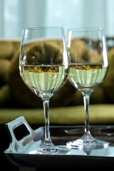 Close-up of two glasses of wine on a serving tray